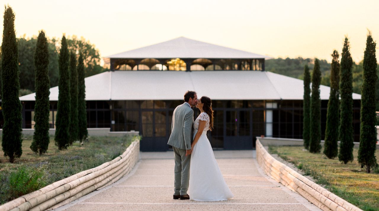 Bride and groom during their wedding at sunset at Château de la Jarthe, France.