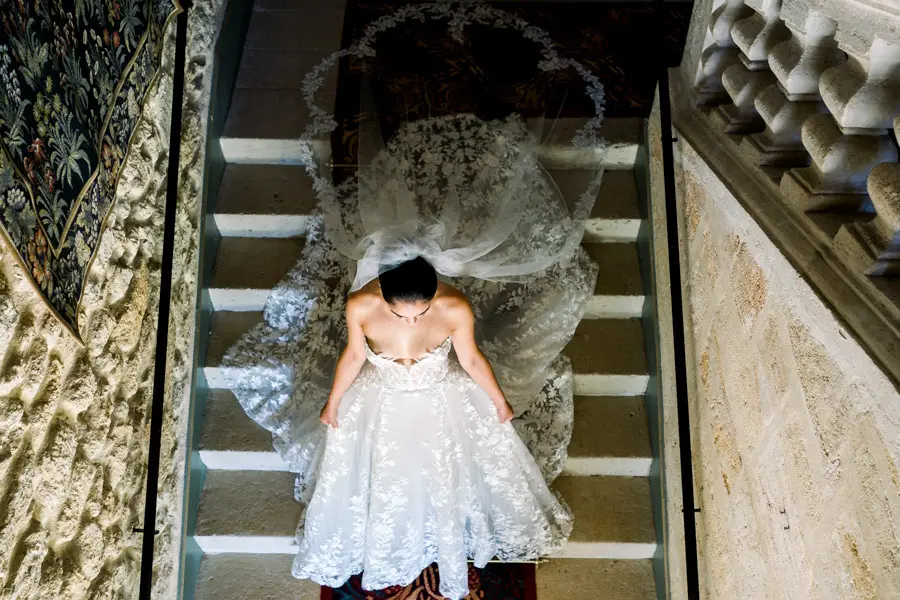Bride on the staircase of Château de la Ligne, seen from above