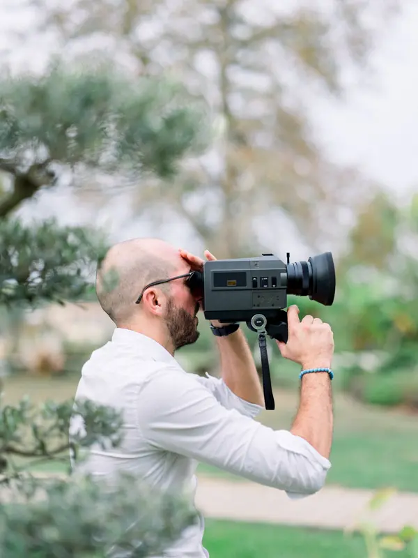 Stephen filming a wedding with a Super 8 camera at Château de Garde
